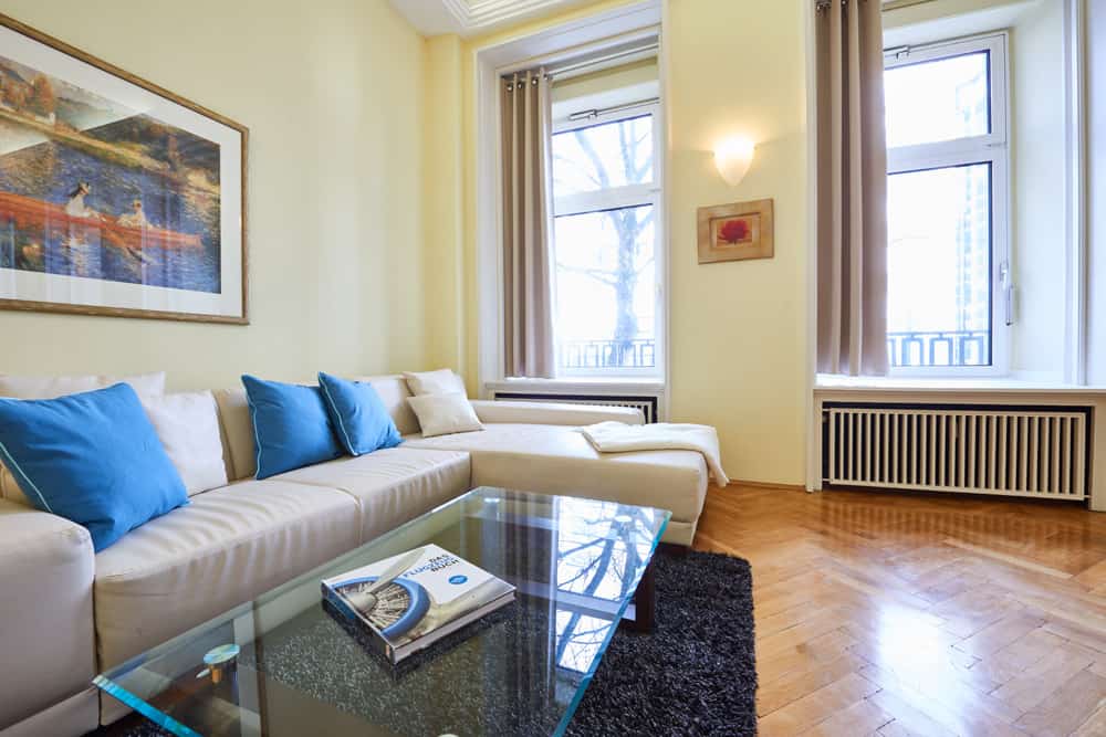 3-room apartment App501 living area sofa glass table carpet parquet